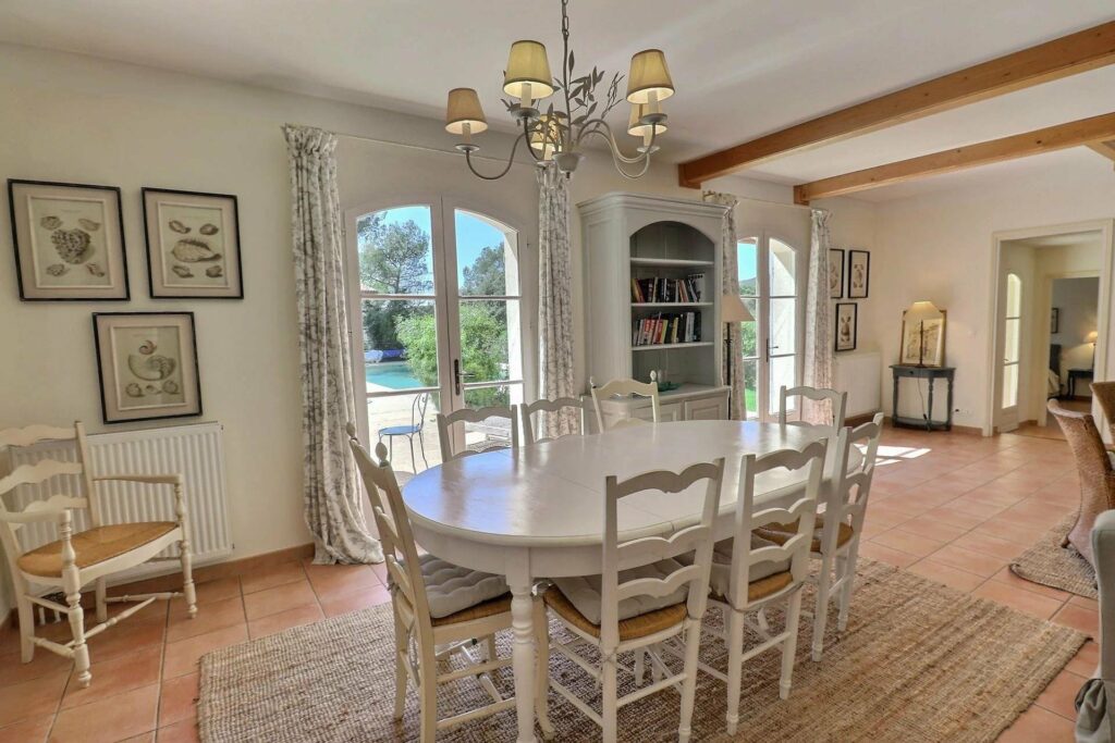 dining room with white wooden table and white hanging chandelier above
