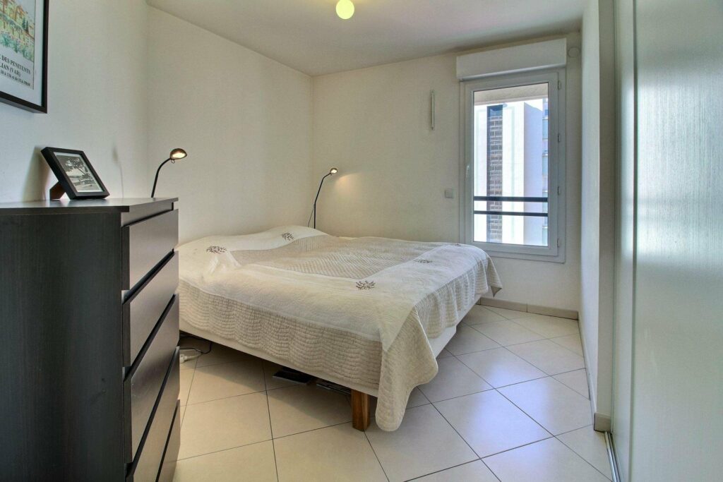 bedroom with king size with bed and white tile floors