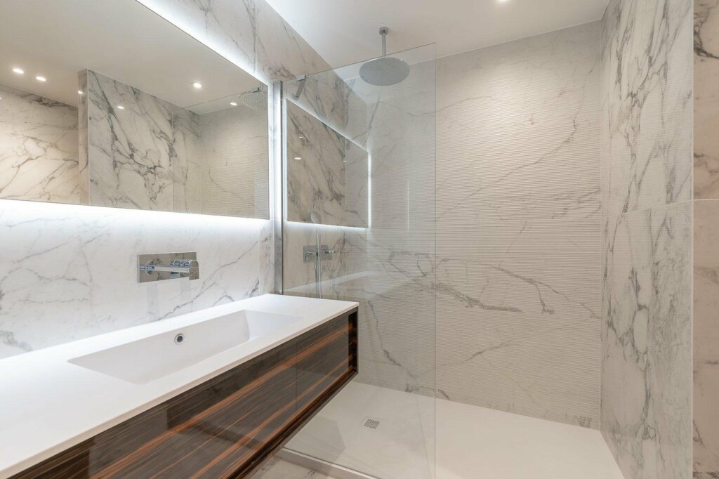 bathroom with all light marble tiling and open shower