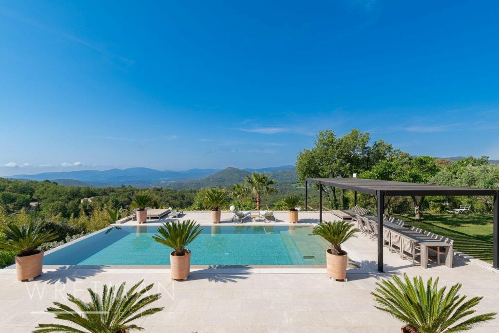 backyard with large infinity pool with view of the mountains