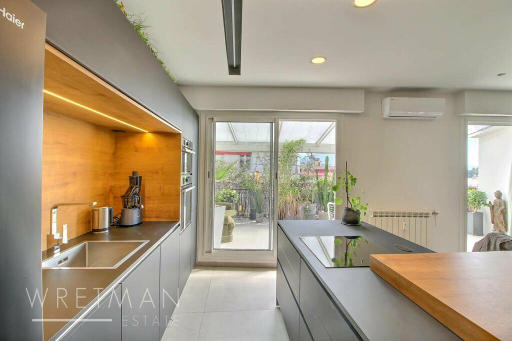 kitchen with grey cabinets and modern design with access to terrace