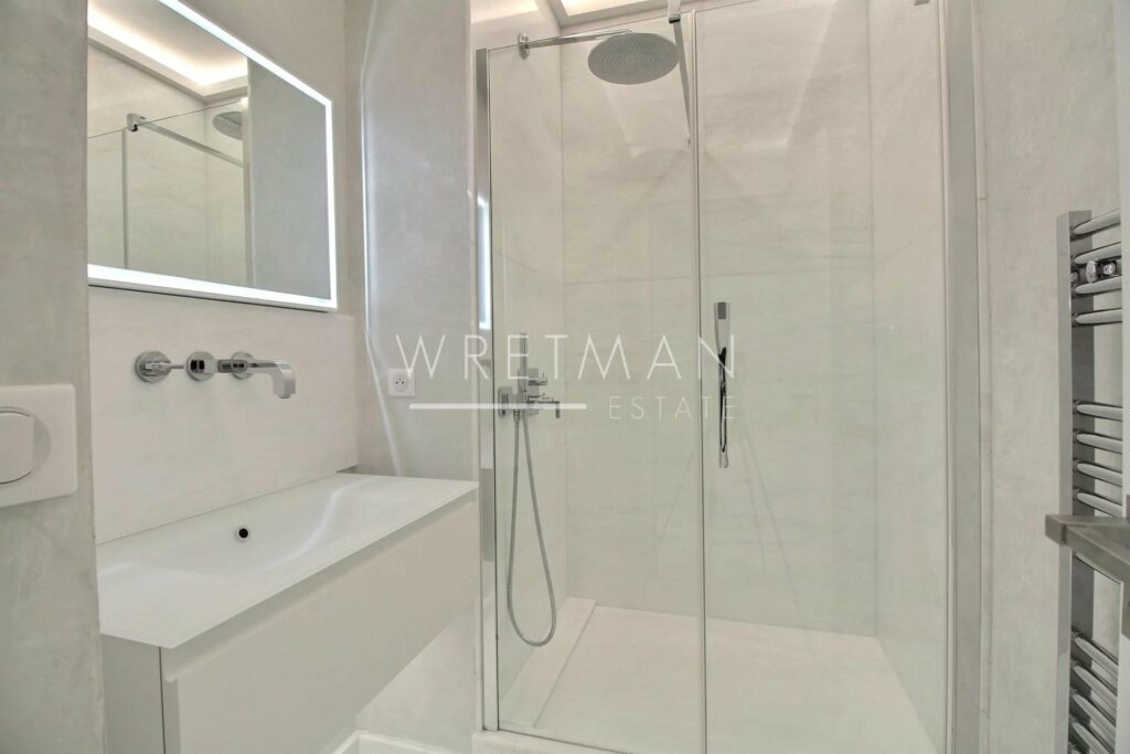 bathroom with white marble floor with standing shower