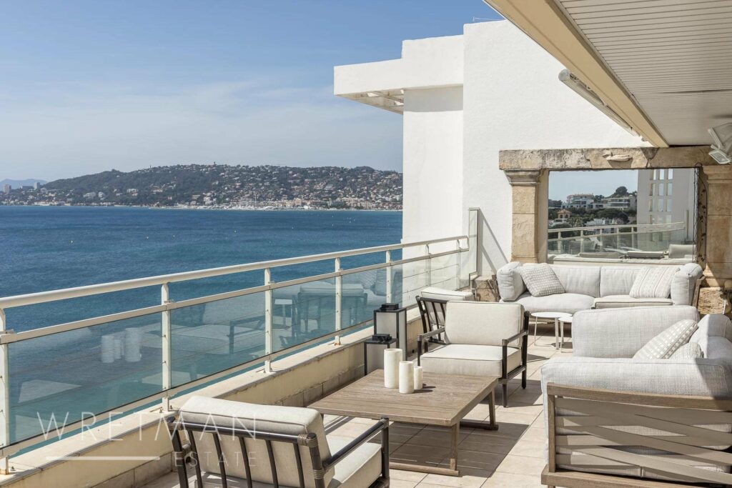 terrace with white modern furniture and sea view in cannes