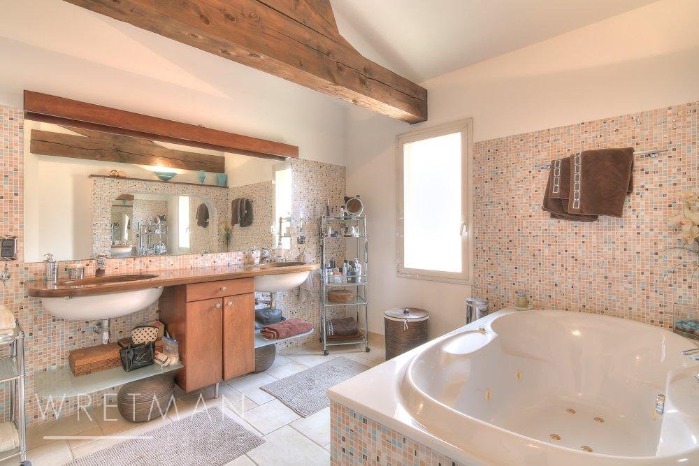 bathroom with white tile floors and exposed beam ceilings