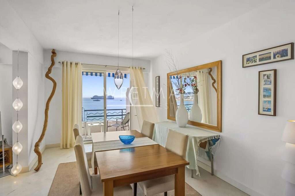 dining room with wood table and view of the harbour from terrace