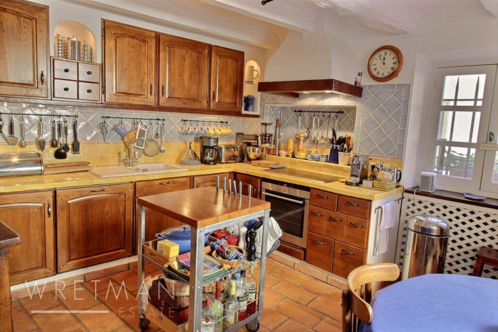 kitchen of village home in grasse with wooden cabinets
