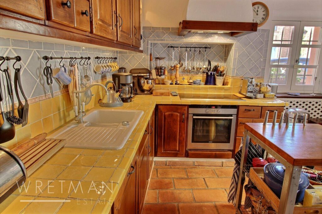 kitchen with yellow tile counter top and wooden cabinets