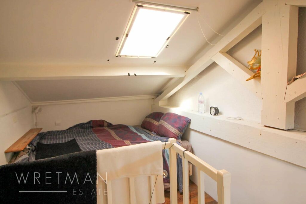 mezzanine bedroom with small skylight