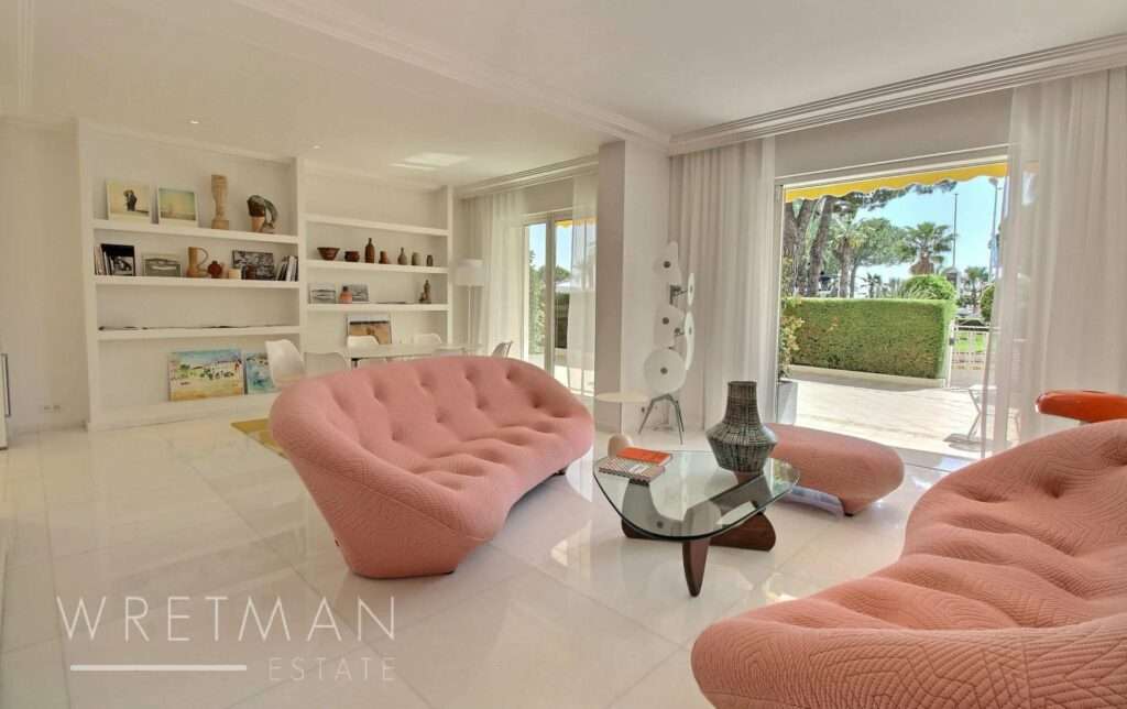 living room with retro pink sofa and white tile floors