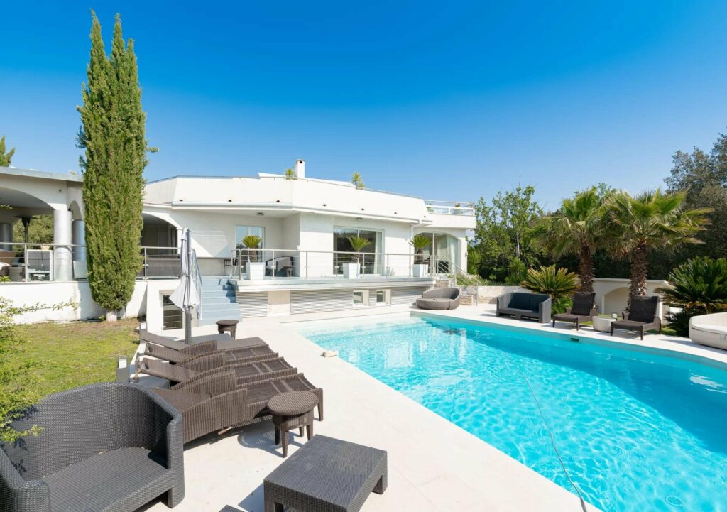 backyard with large swimming pool of modern villa in valbonne