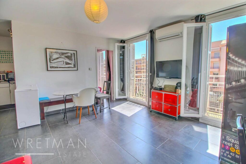 interior of apartment in nice place massena with grey tile floors and floor to ceiling windows