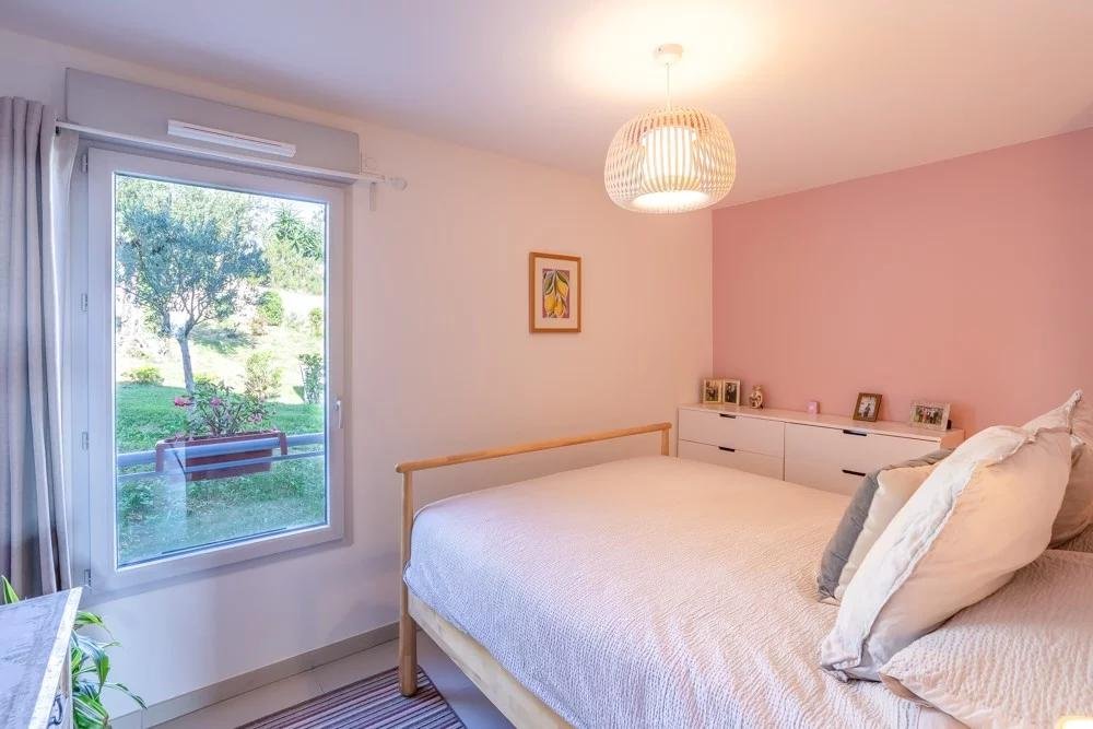 bedroom with white bed and light pink walls