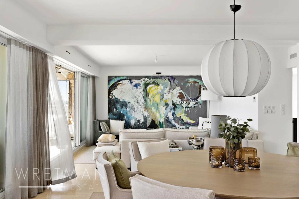 living room with white couch and blue and green contemporary painting