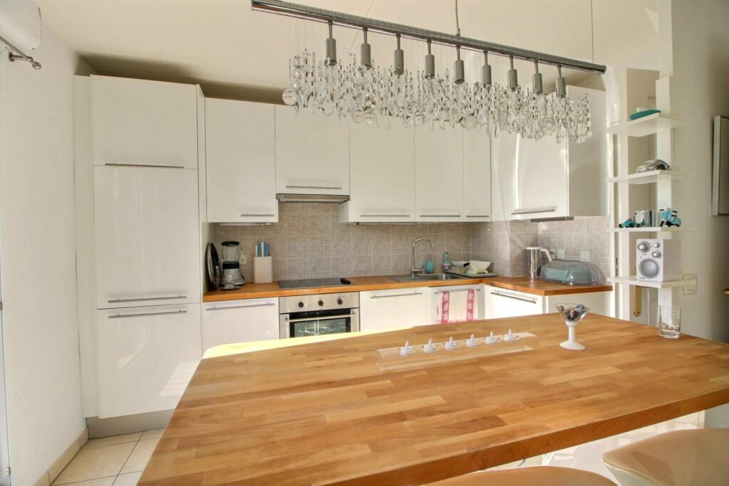 kitchen with white cabinets and large wooden island