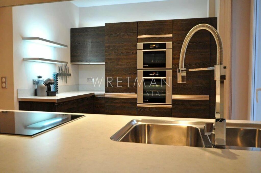 modern kitchen with dark wood cabinets and stainless steal appliances