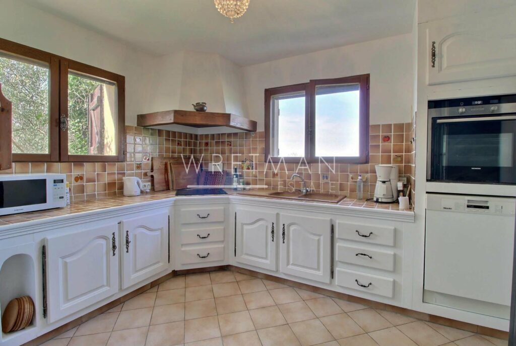 kitchen with white cabinets and beige tile floors