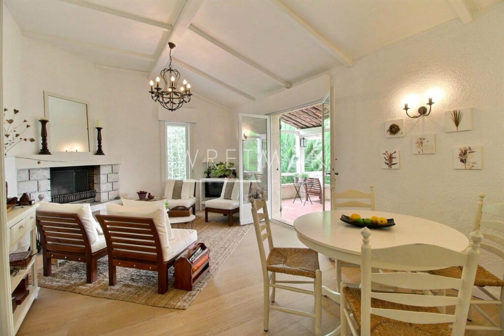 living room with white and wooden chairs next to table