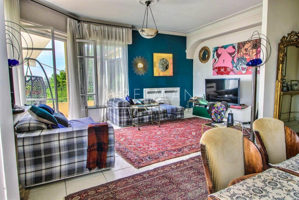 living room with white tile floors and 2 large red rugs and blue plaid couch