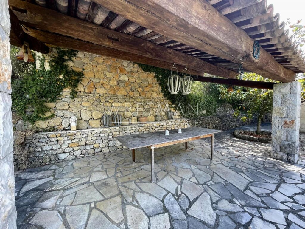back porch with stone floors and outdoor furniture