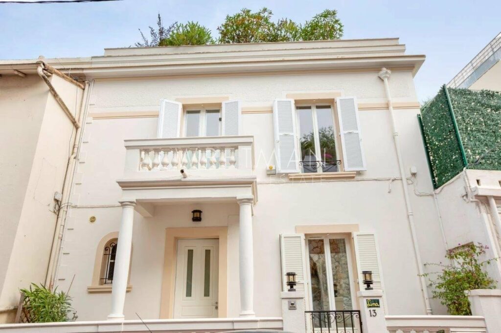 town house villa for sale in cannes with beige exterior and several windows