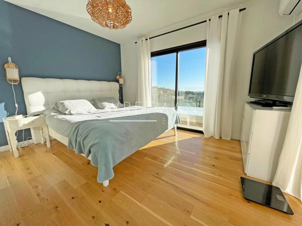 bedroom with wood floors and queen size bed with light blue bedding