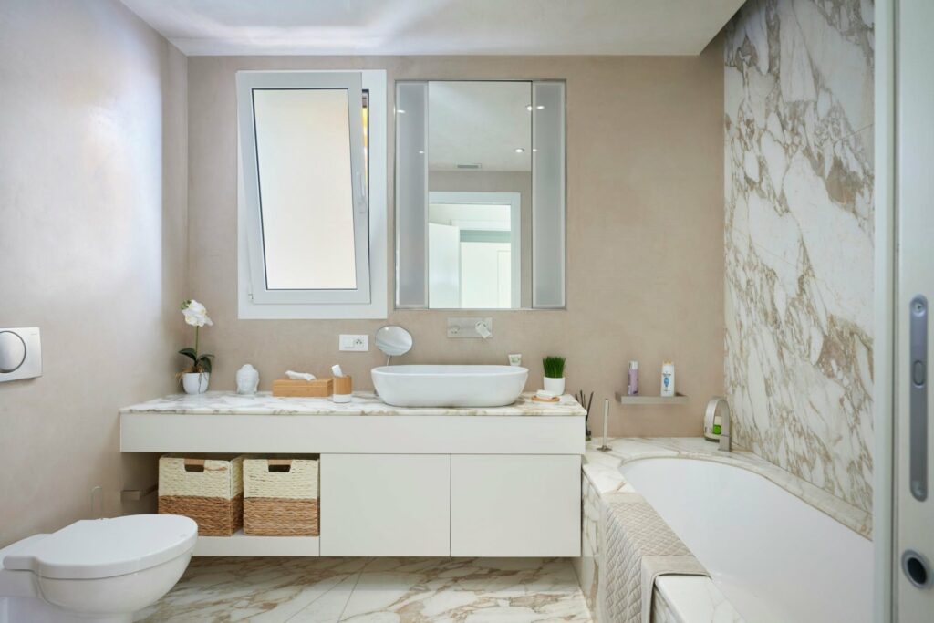 bathroom with white double sink and bath tub