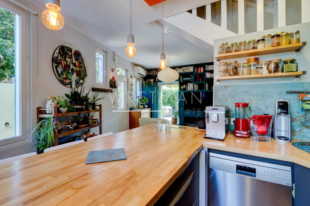 kitchen with wooden counter tops and stainless steel appliance and hanging lights