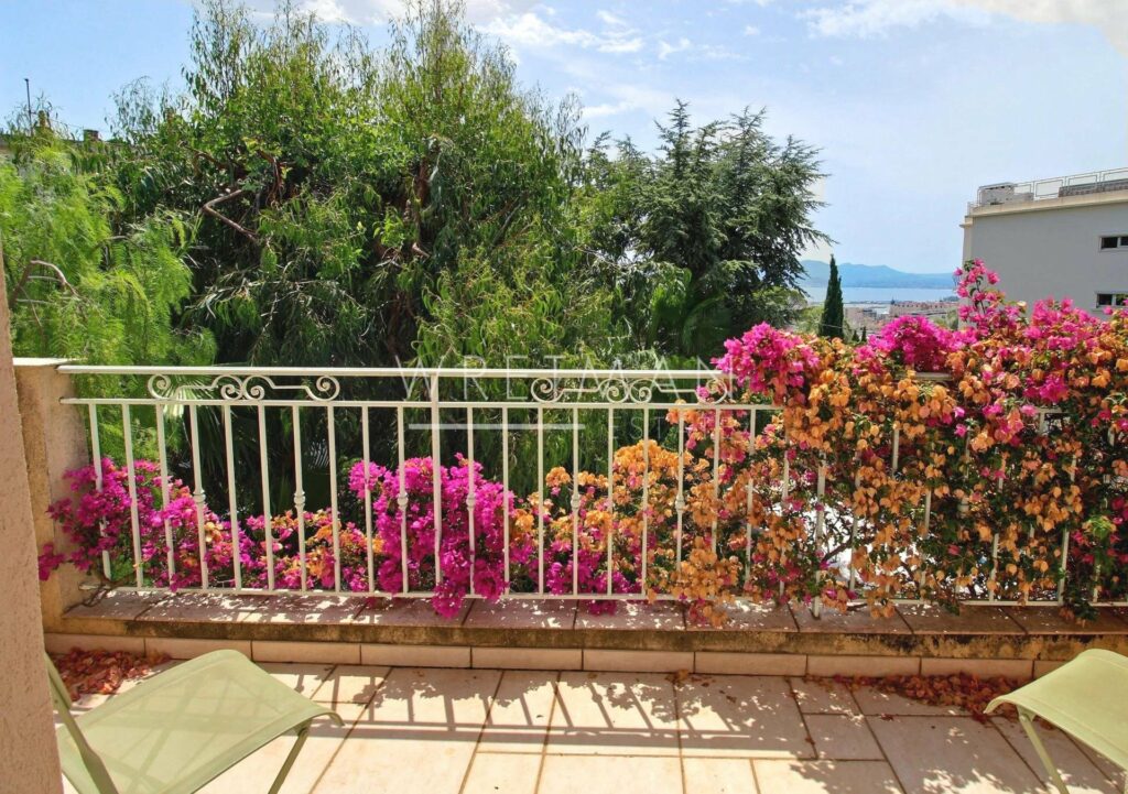 terrace with sea view and view of colorful garden