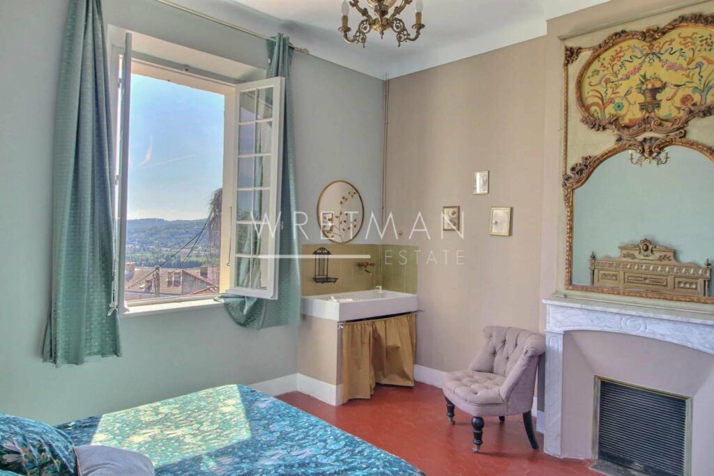 bedroom with classic red tile floors and open window with beautiful view