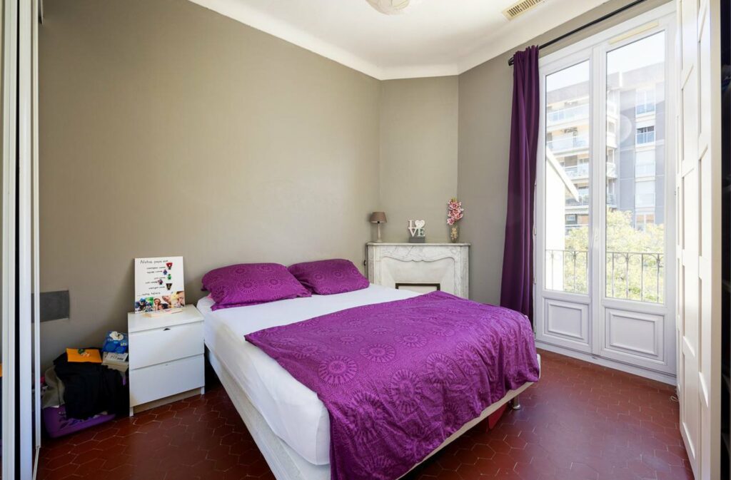 bedroom with double bed with purple bedding