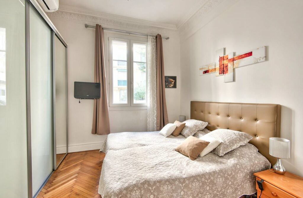 bedroom with beige bed frame and beige bedding