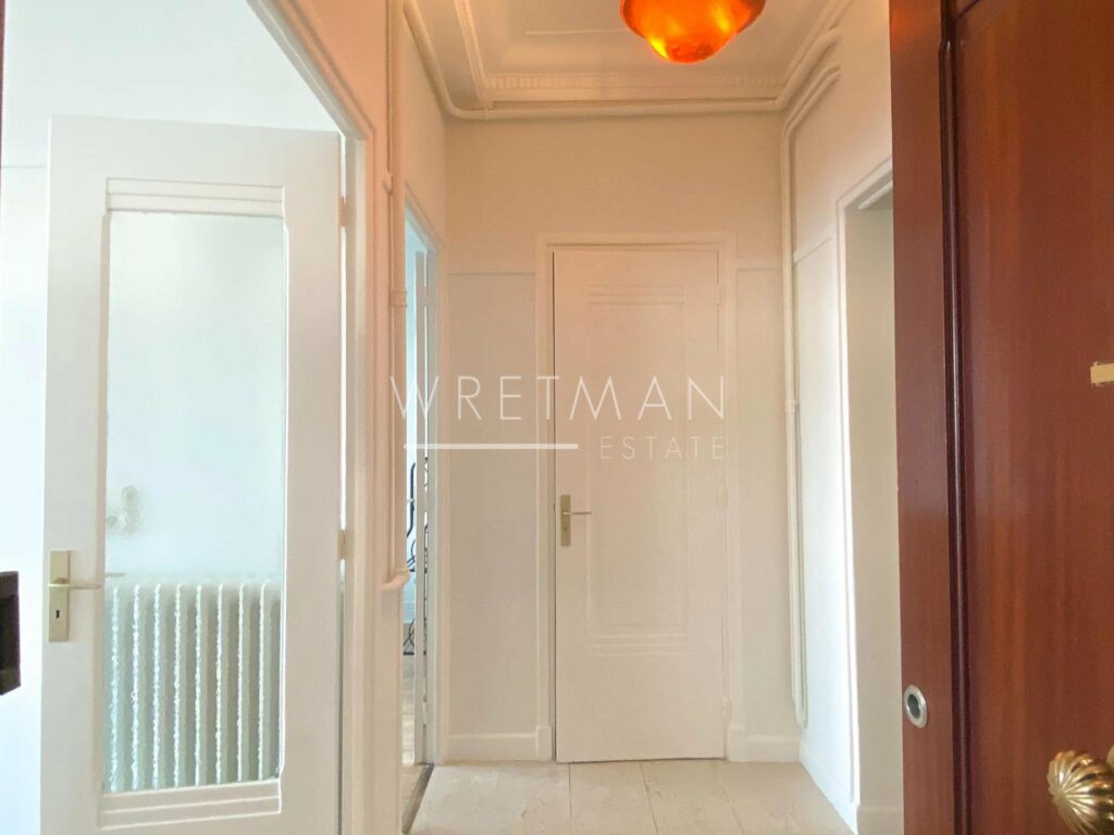 all white hallway of apartment for sale in nice