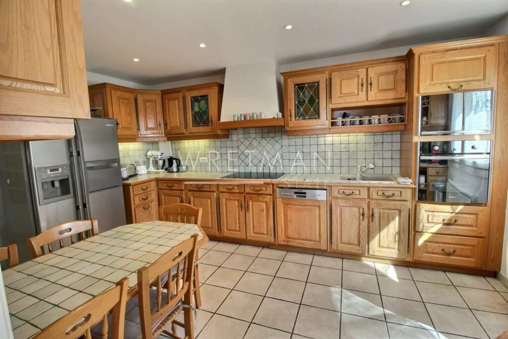 kitchen with brown cabinets and beige tile floors