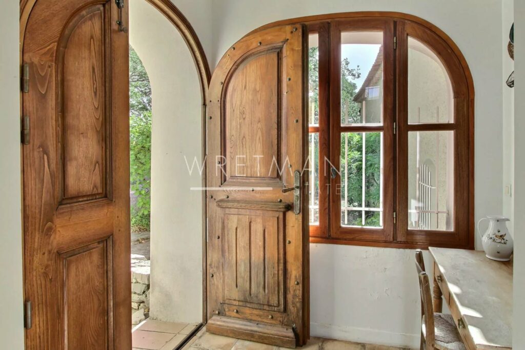 entrance to home with large wooden door