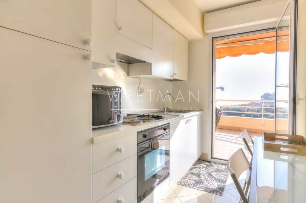 kitchen with white cabinets and access to terrace